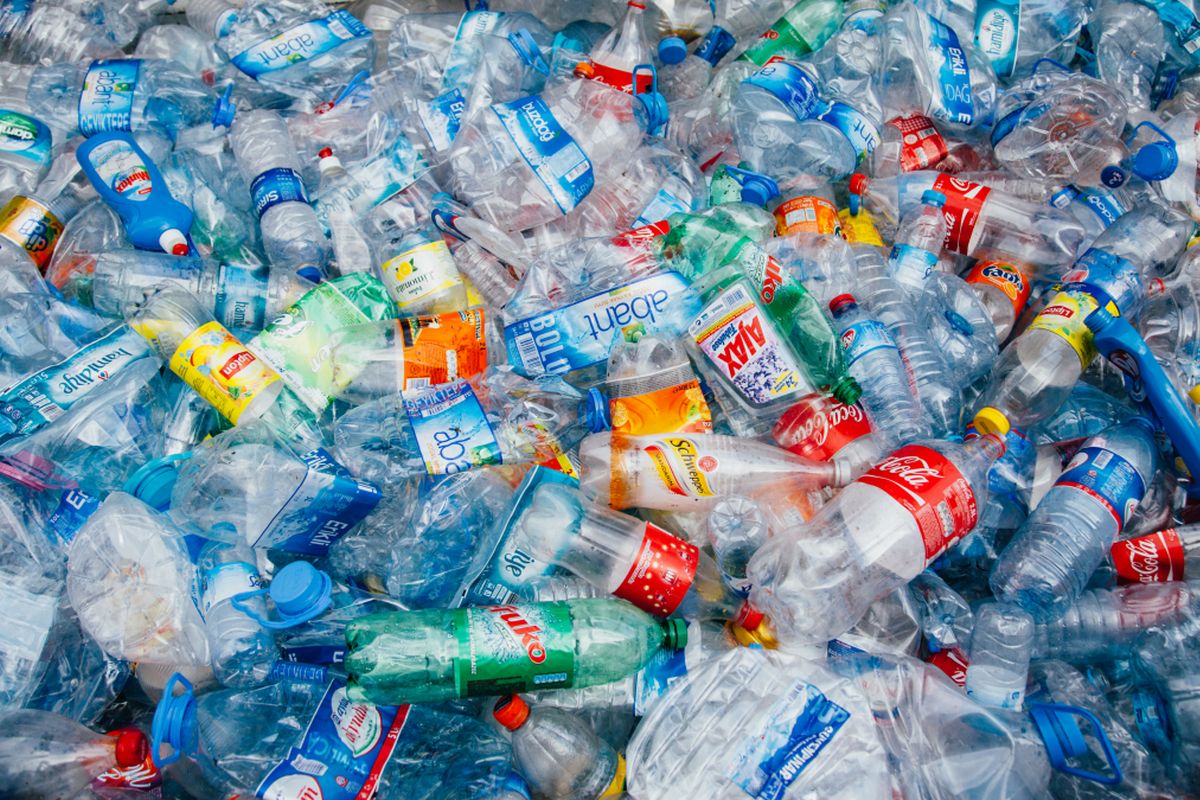 Stack of crushed colorful plastic bottles background waiting for recycle